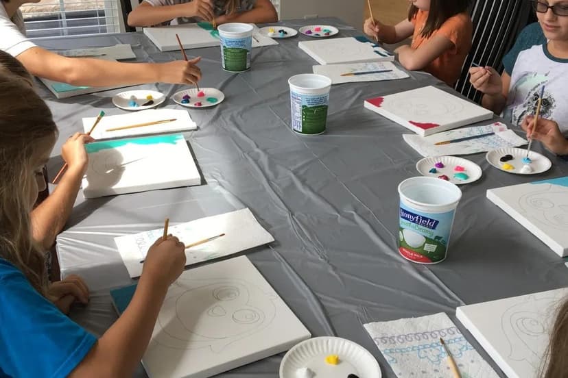 Kids painting on canvases at a birthday paint party