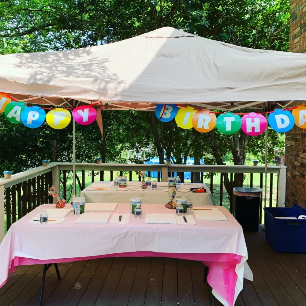 Backyard kids painting party set up under a canopy with blank canvases for the Gilbert, AZ provider directory